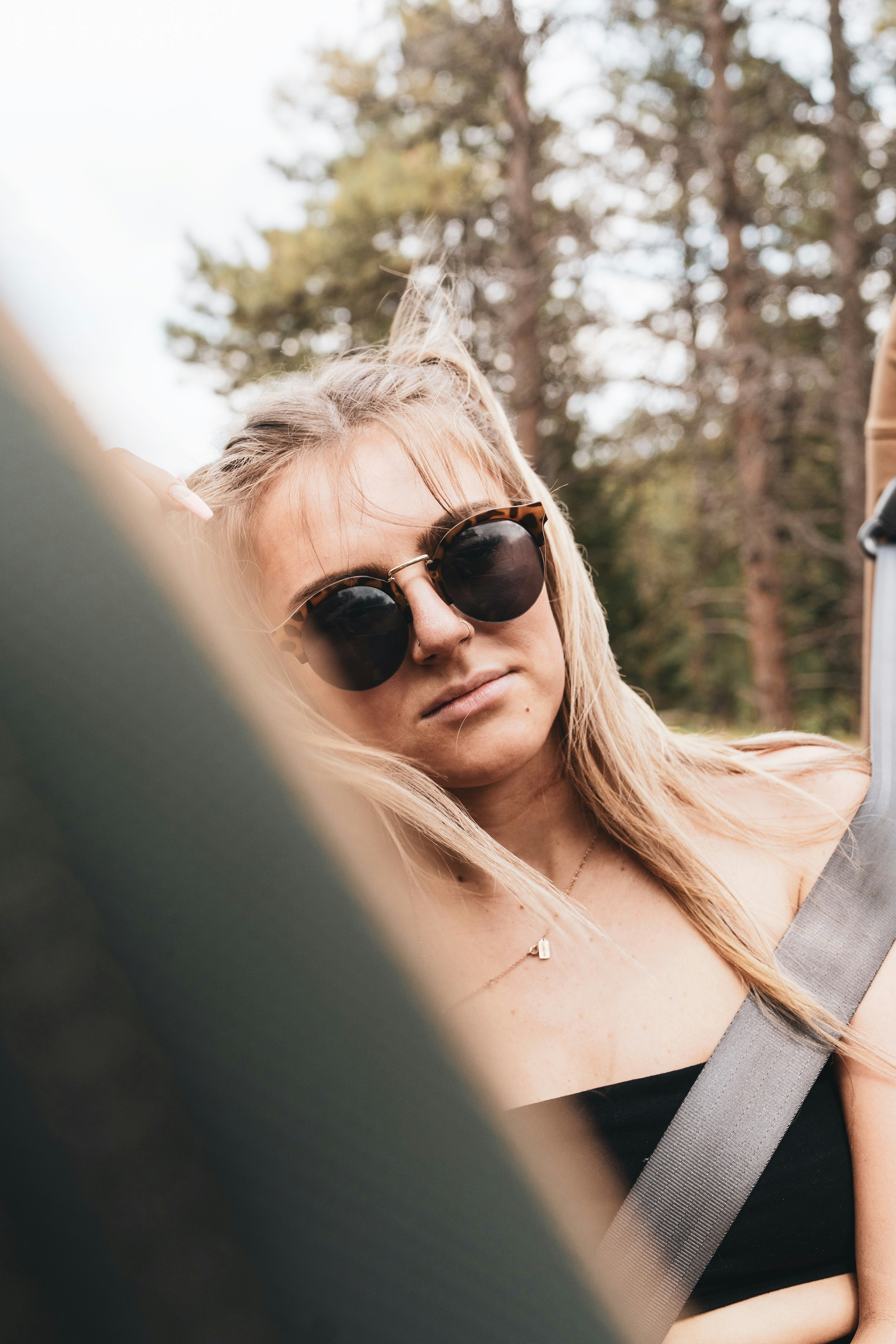 woman in black sunglasses and white shirt